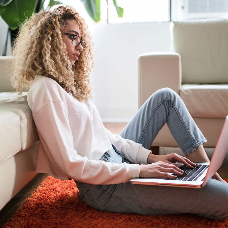 Woman Sitting on Floor Working Woman Sitting on Floor Working